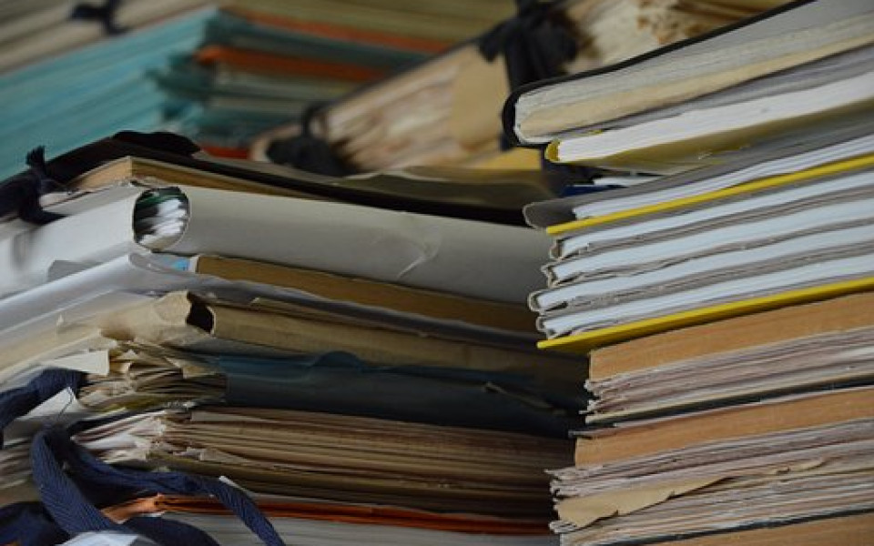 Slightly messy piles of file folders and documents.