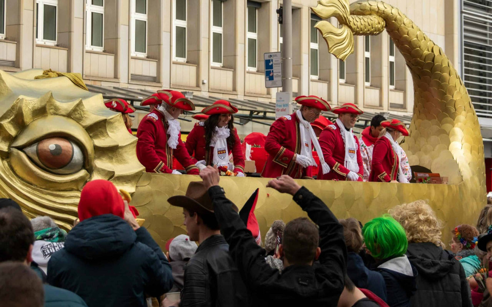A float in a Carnival parade surrounded by an enthusiastic crowd.