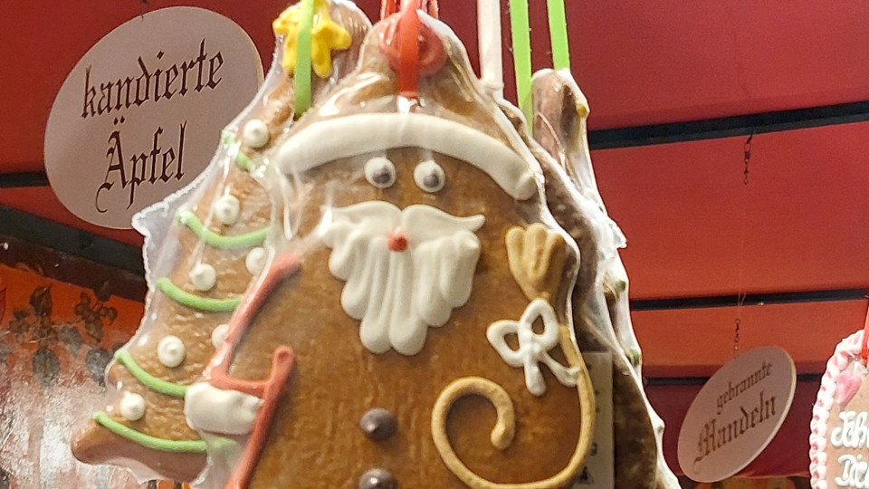 A picture of a gingerbread Santa and gingerbread Christmas tree