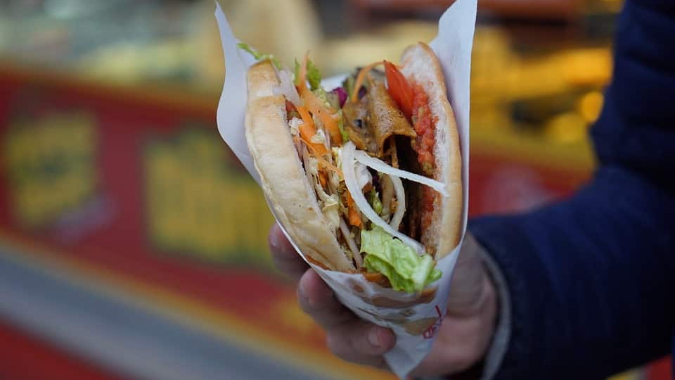 A hand holding a döner.