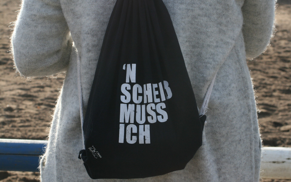 A black backpack with the words 